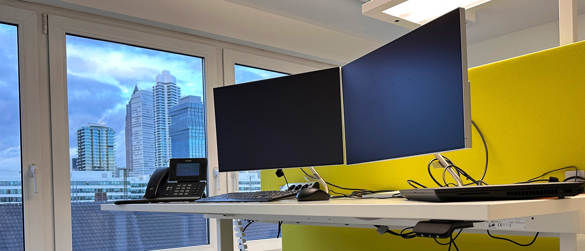Office workspace with laptop and telephone, keyboard and mouse